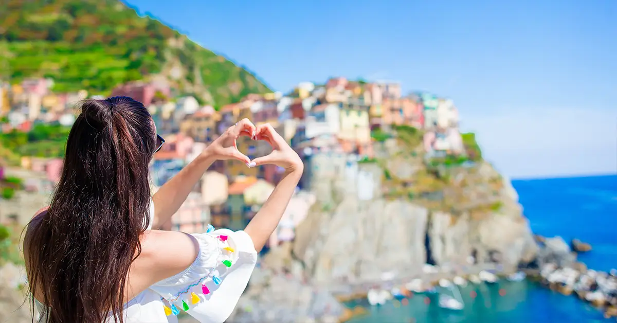 Back view of happy girl in a beautiful view of Manarola Cinque Terre Liguria Italy